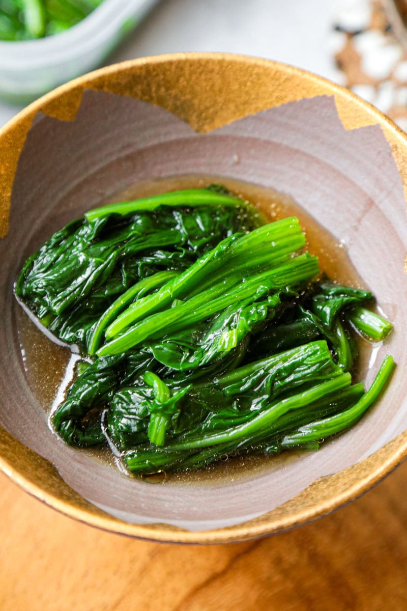 Blanched spinach soaking in a seasoned dashi broth