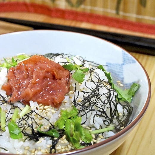 bowl of japanese rice with plum, nori and sesame seeds