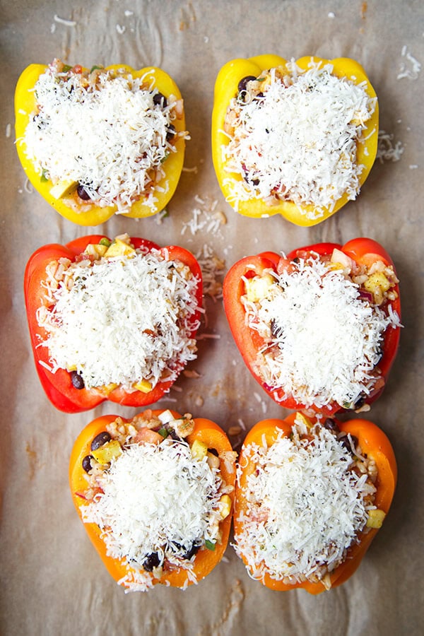 Vegetarian Stuffed Peppers - So colorful and healthy! Serve them as a side or a main and top them with avocado, sour cream and hot sauce. They are filling, delicious and guilt-free! Recipe, vegetarian, vegan, gluten free, healthy | pickledplum.com