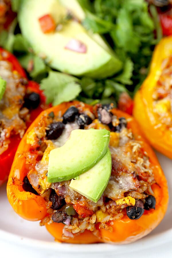 Vegetarian Stuffed Peppers - So colorful and healthy! Serve them as a side or a main and top them with avocado, sour cream and hot sauce. They are filling, delicious and guilt-free! Recipe, vegetarian, vegan, gluten free, healthy | pickledplum.com