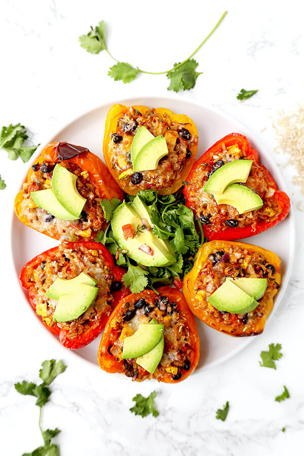 Vegetarian Stuffed Peppers - So colorful and healthy! Serve them as a side or a main and top them with avocado, sour cream and hot sauce. They are filling, delicious and guilt-free! Recipe, vegetarian, vegan, gluten free, healthy | pickledplum.com