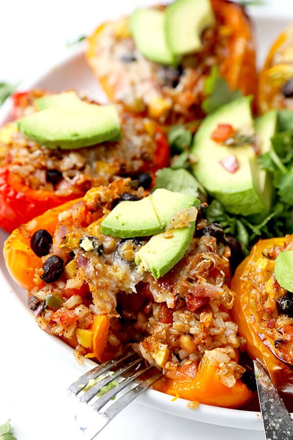 Vegetarian Stuffed Peppers - So colorful and healthy! Serve them as a side or a main and top them with avocado, sour cream and hot sauce. They are filling, delicious and guilt-free! Recipe, vegetarian, vegan, gluten free, healthy | pickledplum.com