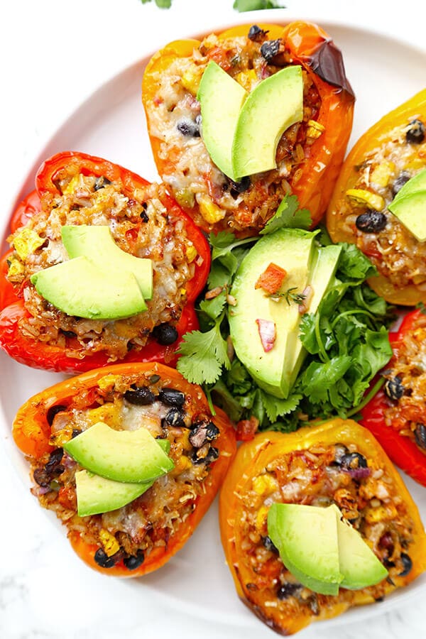 Vegetarian Stuffed Peppers - So colorful and healthy! Serve them as a side or a main and top them with avocado, sour cream and hot sauce. They are filling, delicious and guilt-free! Recipe, vegetarian, vegan, gluten free, healthy | pickledplum.com