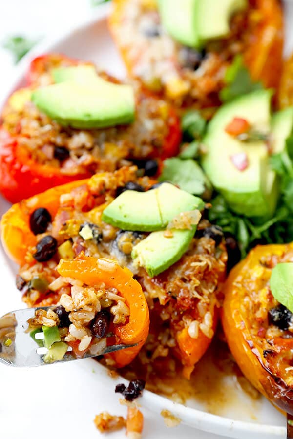 Vegetarian Stuffed Peppers - So colorful and healthy! Serve them as a side or a main and top them with avocado, sour cream and hot sauce. They are filling, delicious and guilt-free! Recipe, vegetarian, vegan, gluten free, healthy | pickledplum.com