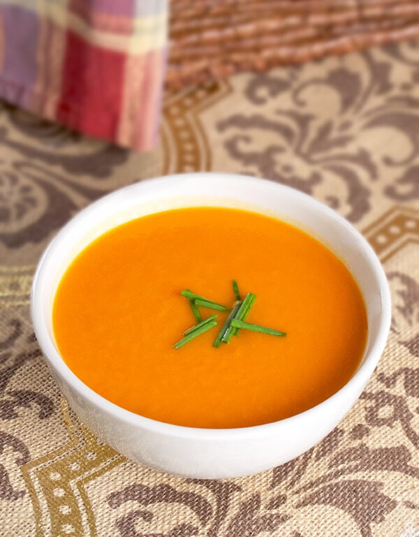 bowl of tomato and sweet potato soup with chives