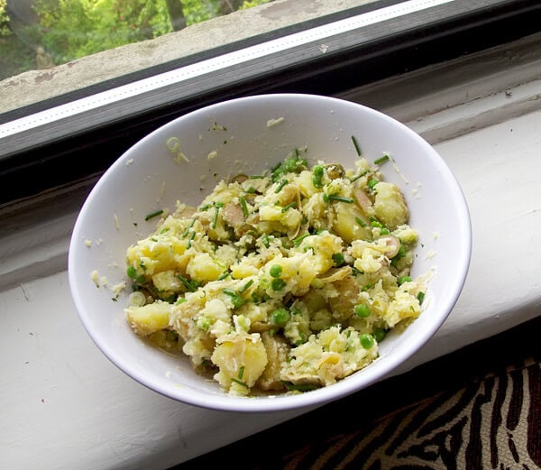 bowl of boiled potatoes with green peas