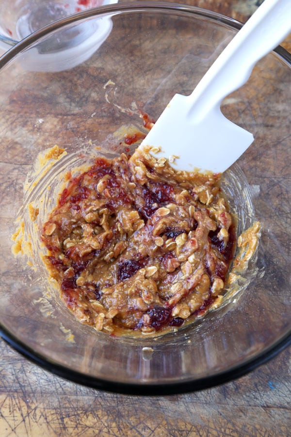 Gluten-free goodness! Chewy, sweet and fruity, these gluten-free peanut butter and raspberry jam cookies are so good you won't be able to stop at just one! #glutenfreecookies #glutenfreerecipes #flourless #homemadecookies | pickledplum.com