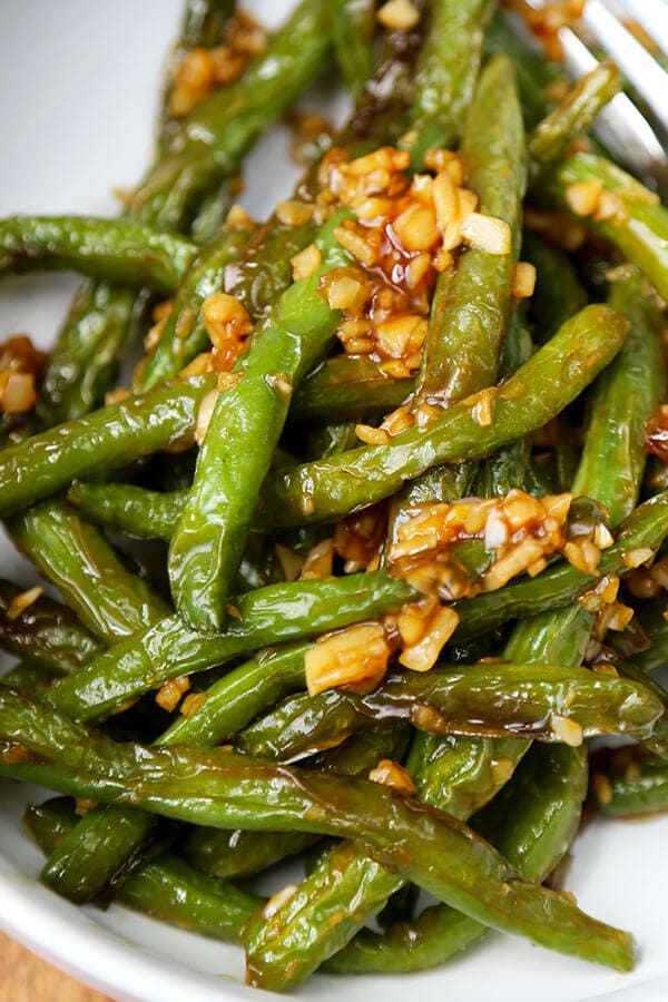 Dry-fried green beans - a delicious Chinese side dishes that's vegetarian and only requires a few ingredients! Savory, garlicky and tender green beans to add to your Asian dinner recipes rotation! #airfryer #chineserecipes #vegetarian #healthyrecipes | pickledplum.com