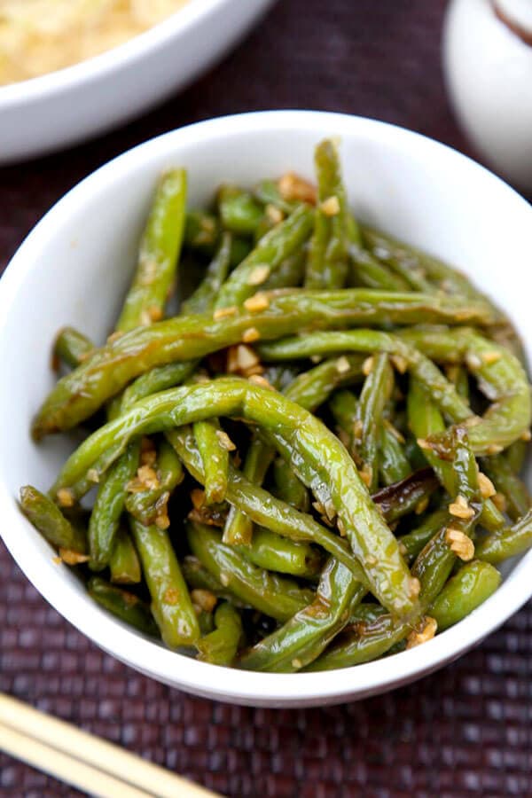 Dry-fried green beans - a delicious Chinese side dishes that's vegetarian and only requires a few ingredients! Savory, garlicky and tender green beans to add to your Asian dinner recipes rotation! #airfryer #chineserecipes #vegetarian #healthyrecipes | pickledplum.com