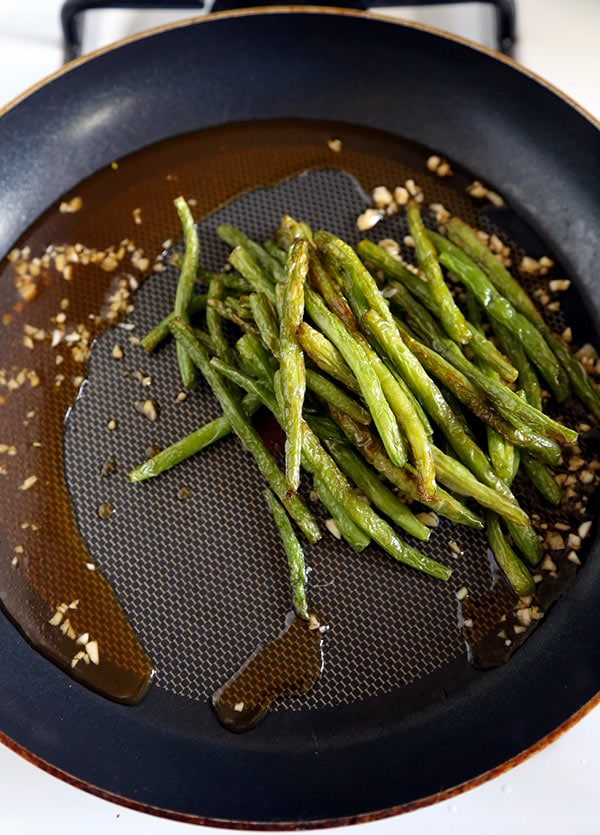 Dry-fried green beans - a delicious Chinese side dishes that's vegetarian and only requires a few ingredients! Savory, garlicky and tender green beans to add to your Asian dinner recipes rotation! #airfryer #chineserecipes #vegetarian #healthyrecipes | pickledplum.com