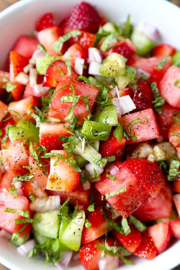 Watermelon, Strawberry and Tomatillo Salad - This is a bright and light strawberry salad tossed with fresh watermelon and tomatillos. It's the perfect mélange of sweetness and tartness that will fuel your body full of vitamin C! Plus, it only takes 10 minutes to make! #veganrecipes #healthyeating #strawberrysalad #saladrecipes | pickledplum.com