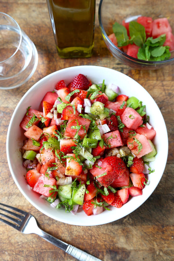 Watermelon, Strawberry and Tomatillo Salad - This is a bright and light strawberry salad tossed with fresh watermelon and tomatillos. It's the perfect mélange of sweetness and tartness that will fuel your body full of vitamin C! Plus, it only takes 10 minutes to make! #veganrecipes #healthyeating #strawberrysalad #saladrecipes | pickledplum.com
