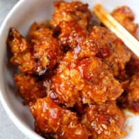 General Tso Chicken - A General Tso Chicken recipe that's baked, not fried and so much better than the real thing! Crispy and tender chicken pieces baked in crushed cornflakes and dressed in a classic sweet and sour sauce. #chinesefood #chickenrecipes #homemade #healthy #bakednotfried | pickledplum.com