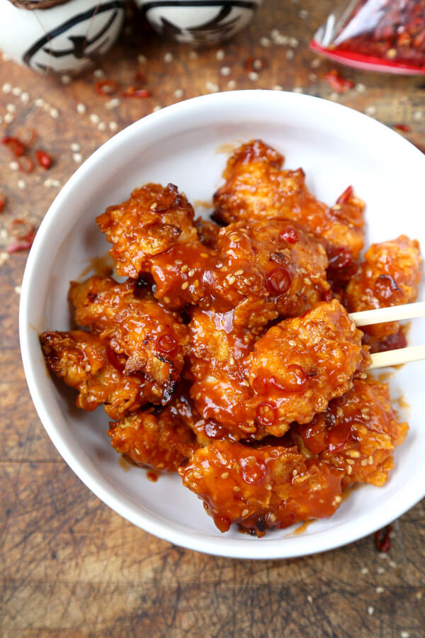 General Tso Chicken - A General Tso Chicken recipe that's baked, not fried and so much better than the real thing! Crispy and tender chicken pieces baked in crushed cornflakes and dressed in a classic sweet and sour sauce. #chinesefood #chickenrecipes #homemade #healthy #bakednotfried | pickledplum.com