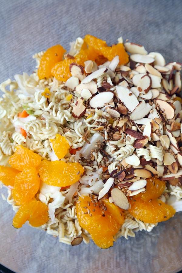 Ramen Noodle Coleslaw - This is an easy ramen noodle salad recipe with cabbage, mandarin oranges, slivered almonds and crunchy ramen noodles, tossed in an oriental dressing that's sweet and tangy. Yummy! #saladrecipe #asiansalad #ramennoodles| pickledplum.com