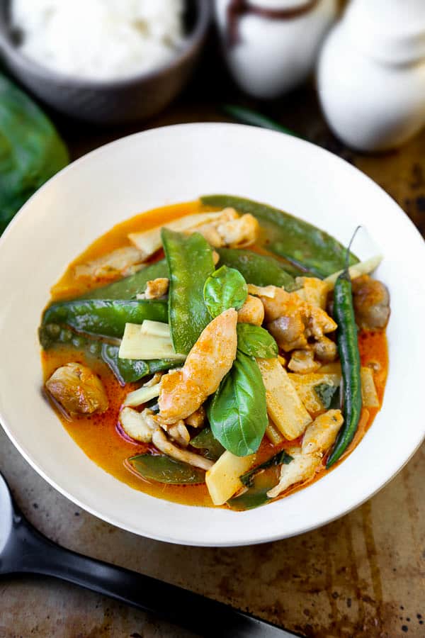 Thai Red Chicken Curry - an authentic thai coconut curry recipe that's easy and healthy! Make it spicy (or not) and add your favorite ingredients. I've added chicken, bamboo and snow peas. Delicious! #thaifood #curryrecipe #asianrecipes #chickenrecipes #currypaste pickledplum.com