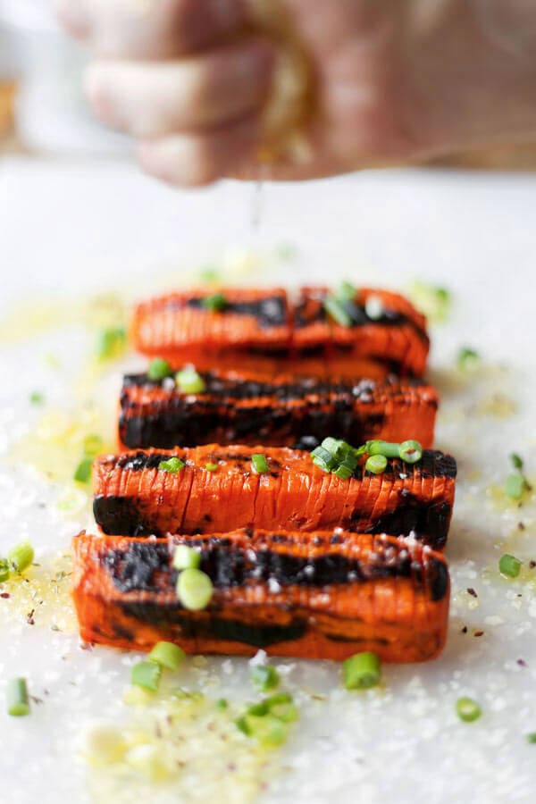 Blackened Hasselback Carrots - These Hasselback carrots only take 20 minutes to make and have the perfect tender/crunchy texture, topped with some sea salt and a fresh squeeze of lemon juice. Scrumptious!Fancy looking carrots you say? These Hasselback carrots are very easy to make, have the perfect tender/crunchy texture and are topped with scallions, sea salt and a fresh squeeze of lemon juice. Scrumptious! Vegan, Gluten free, Healthy Recipe | pickledplum.com 