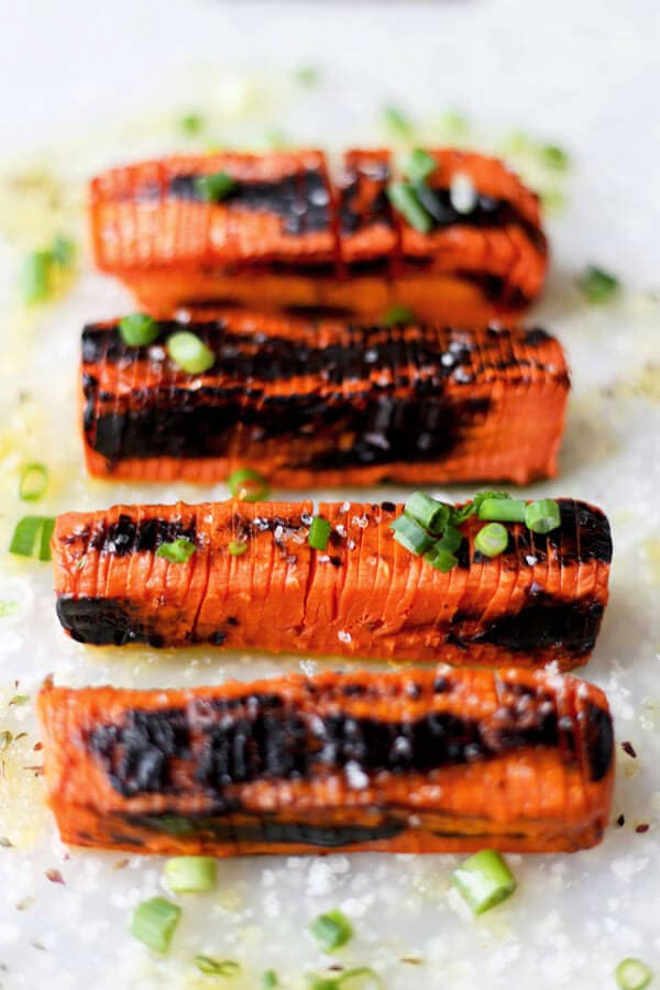 Blackened Hasselback Carrots - These Hasselback carrots only take 20 minutes to make and have the perfect tender/crunchy texture, topped with some sea salt and a fresh squeeze of lemon juice. Scrumptious!Fancy looking carrots you say? These Hasselback carrots are very easy to make, have the perfect tender/crunchy texture and are topped with scallions, sea salt and a fresh squeeze of lemon juice. Scrumptious! Vegan, Gluten free, Healthy Recipe | pickledplum.com 