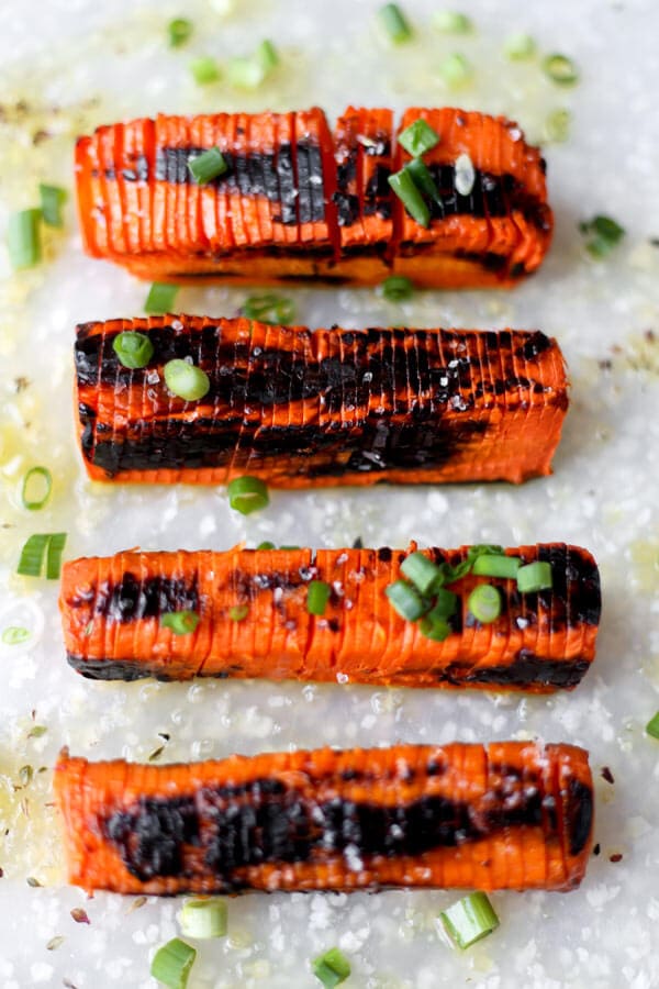 Blackened Hasselback Carrots - These Hasselback carrots only take 20 minutes to make and have the perfect tender/crunchy texture, topped with some sea salt and a fresh squeeze of lemon juice. Scrumptious!Fancy looking carrots you say? These Hasselback carrots are very easy to make, have the perfect tender/crunchy texture and are topped with scallions, sea salt and a fresh squeeze of lemon juice. Scrumptious! Vegan, Gluten free, Healthy Recipe | pickledplum.com 