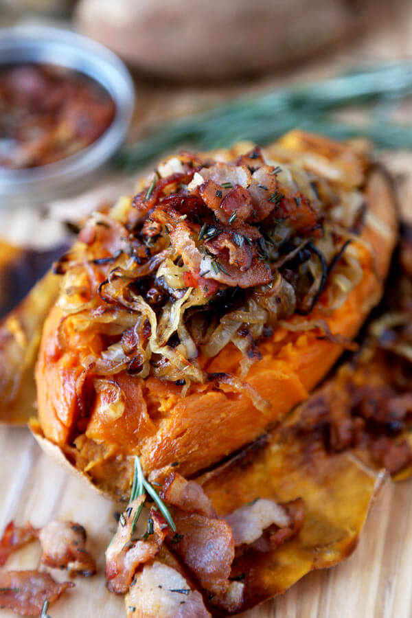 A fun and delicious way to eat potatoes! This baked sweet potato recipe is loaded with caramelized onions, fresh rosemary and crispy bacon for a tasty treat! | pickledplum.com