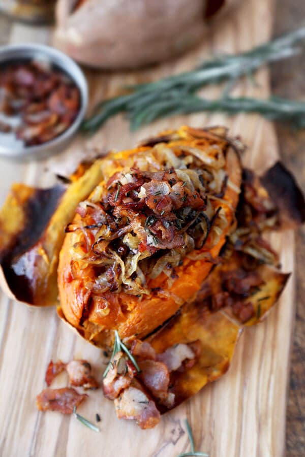 A fun and delicious way to eat potatoes! This baked sweet potato recipe is loaded with caramelized onions, fresh rosemary and crispy bacon for a tasty treat! | pickledplum.com