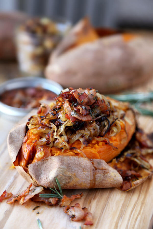 A fun and delicious way to eat potatoes! This baked sweet potato recipe is loaded with caramelized onions, fresh rosemary and crispy bacon for a tasty treat! | pickledplum.com