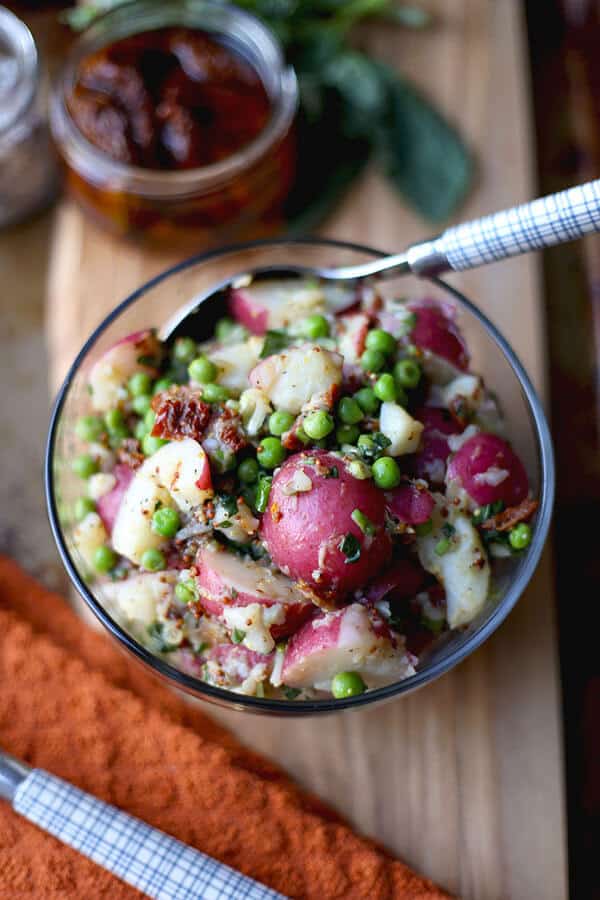 Healthy Red Potato Salad - A deliciously healthy and tangy red potato salad with sun dried tomatoes, green peas and basil, tossed in a light mustard and vinegar dressing. Ready in 15 minutes! 