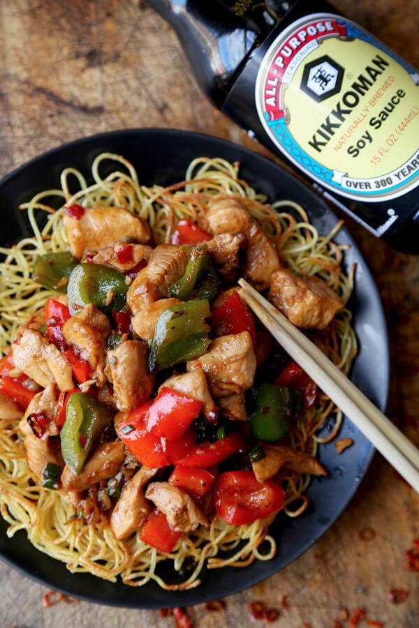 Kung Pao Chicken Recipe - Celebrate Chinese new year with this traditional and delicious kung pao chicken recipe! Served on crispy noodle cakes, it's a fun and colorful meal to enjoy with friends and family! | pickledplum.com