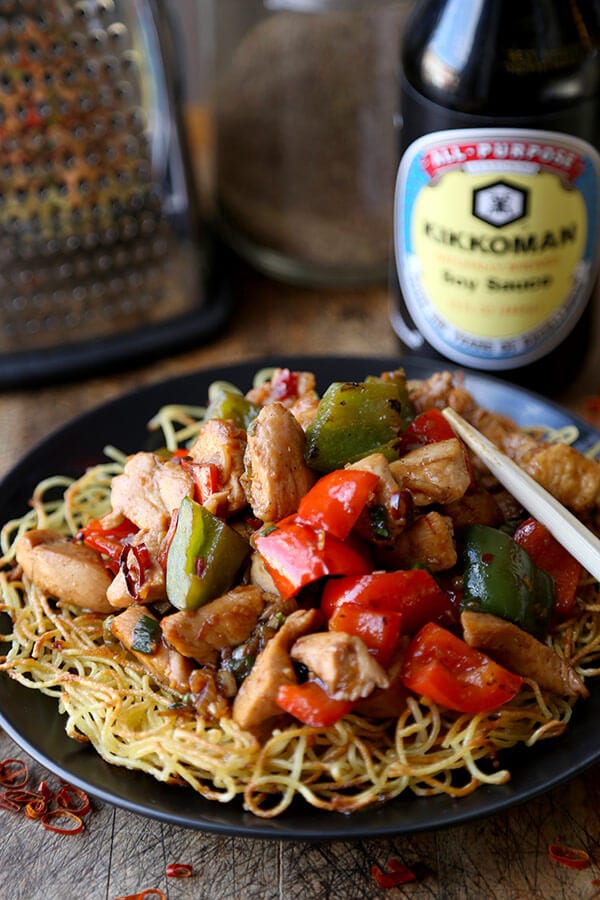 Kung Pao Chicken Recipe - Celebrate Chinese new year with this traditional and delicious kung pao chicken recipe! Served on crispy noodle cakes, it's a fun and colorful meal to enjoy with friends and family! | pickledplum.com