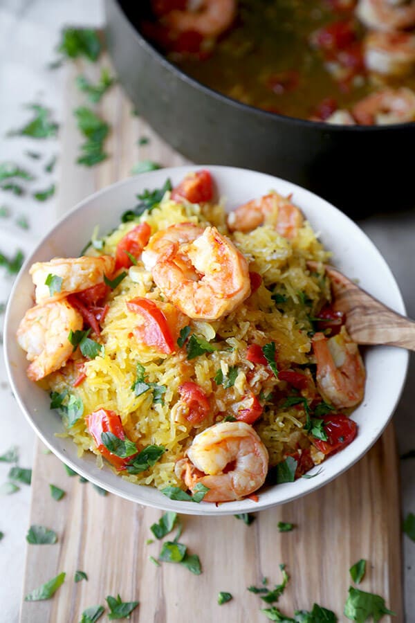 Shrimp scampi spaghetti squash - salty, lemony, buttery shrimp over a healthy bowl of spaghetti squash tossed in savory parmesan cheese. Totally yummy and ready in just 25 minutes! | pickledplum.com