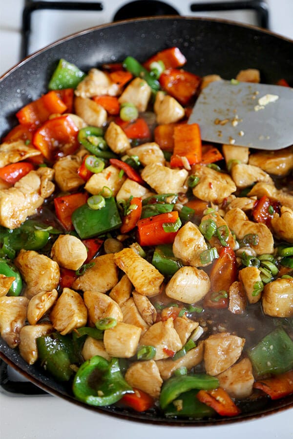 Kung Pao Chicken Recipe - Celebrate Chinese new year with this traditional and delicious kung pao chicken recipe! Served on crispy noodle cakes, it's a fun and colorful meal to enjoy with friends and family! | pickledplum.com