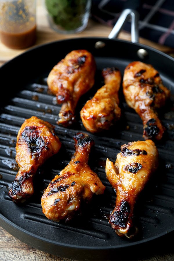 Hoisin Chicken with Pickled Cucumber Salad - Baked chicken drumsticks glazed with a sweet and tangy hoisin sauce that's finger licking good! Simple and easy and the perfect companion to a bowl of steamed white rice! | pickledplum.com