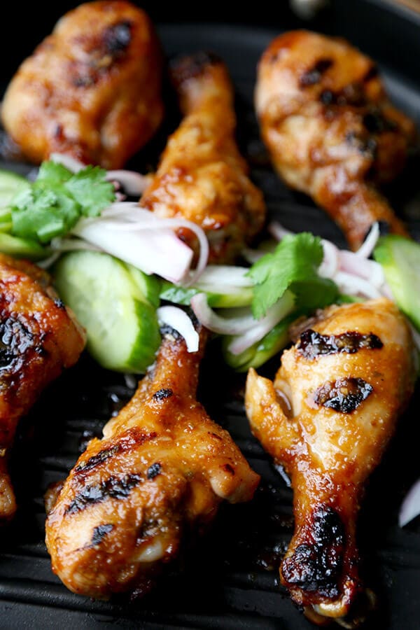 Hoisin Chicken with Pickled Cucumber Salad - Baked chicken drumsticks glazed with a sweet and tangy hoisin sauce that's finger licking good! Simple and easy and the perfect companion to a bowl of steamed white rice! | pickledplum.com