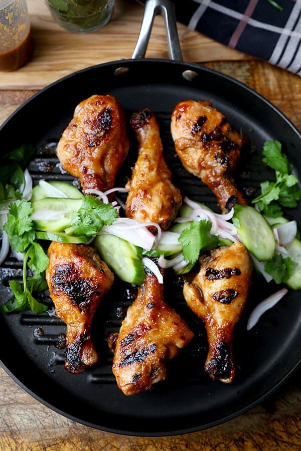 Hoisin Chicken with Pickled Cucumber Salad - Baked chicken drumsticks glazed with a sweet and tangy hoisin sauce that's finger licking good! Simple and easy and the perfect companion to a bowl of steamed white rice! | pickledplum.com