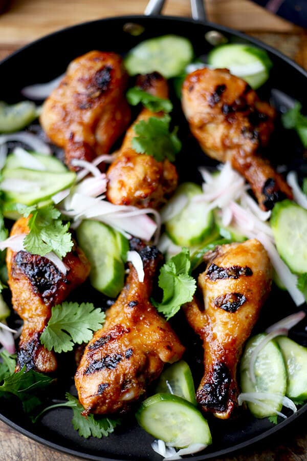 Hoisin Chicken with Pickled Cucumber Salad - Baked chicken drumsticks glazed with a sweet and tangy hoisin sauce that's finger licking good! Simple and easy and the perfect companion to a bowl of steamed white rice! | pickledplum.com