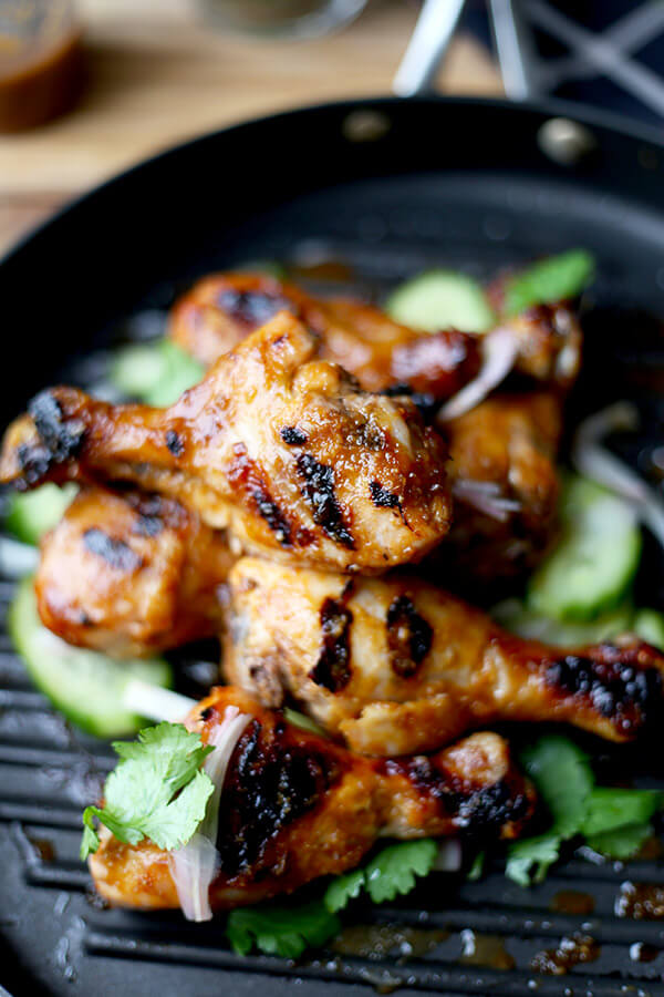 Hoisin Chicken with Pickled Cucumber Salad - Baked chicken drumsticks glazed with a sweet and tangy hoisin sauce that's finger licking good! Simple and easy and the perfect companion to a bowl of steamed white rice! | pickledplum.com