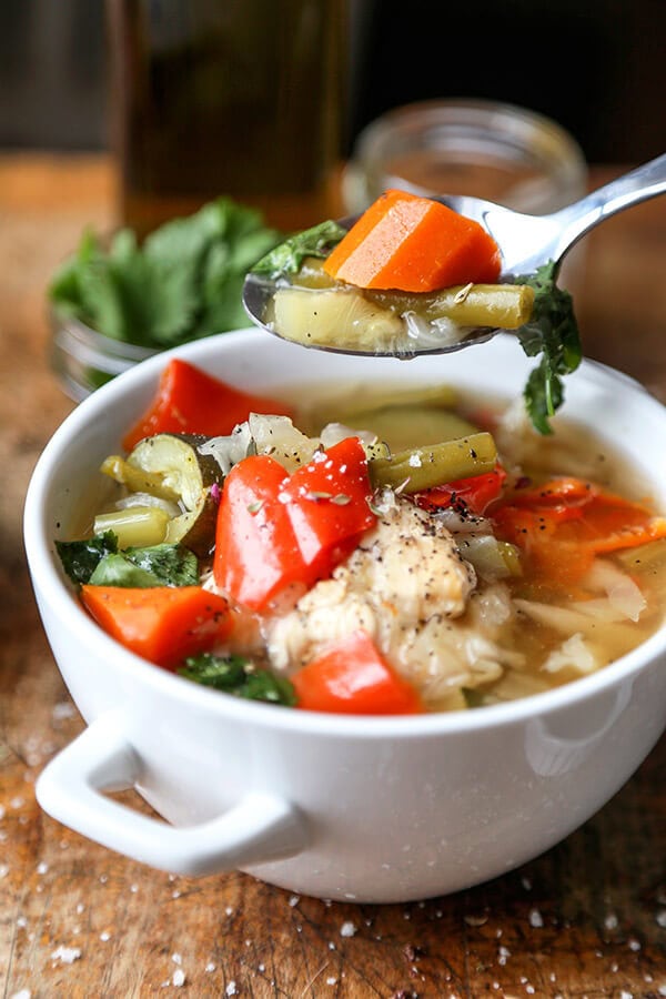 Slow Cooker Chicken Soup - This simple slow cooker chicken soup is packed with veggies and simmered in a light and delicate chicken stock. It's low in calories and fat and only takes 10 minutes to prep. Gluten free, weight loss. | pickledplum.com