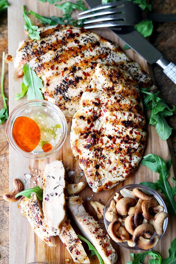 grilled chicken cutlets with hot and sweet sauce with arugula and cashew nuts