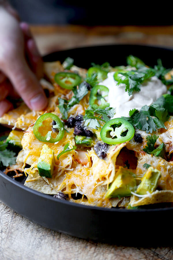 Loaded Nachos With Kimchi And Miso Crema - Six minutes in the oven is all it takes to transform this Loaded Nachos with Kimchi and Miso Crema Recipe into a spicy, cheesy and delicious snack! Recipe, snack, tortillas, superbowl, barbecue, chips | pickledplum.com