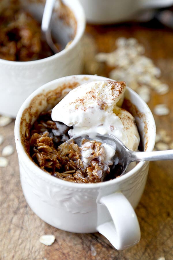 Apple Crumble Mug Cake - A sweet, chewy and fruit loaded Apple Crumble Mug Cake Recipe that tastes divine with a scoop of creamy vanilla ice cream! Ready in 15 minutes or less. Recipe, dessert, apples, ice cream, snack, treat, crumble | pickledplum.com