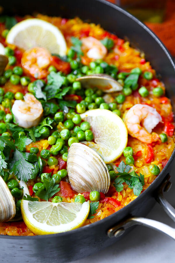 Easy Seafood Paella Recipe - A smoky and Easy Seafood Paella Recipe that looks and tastes like a sun-soaked summer on the Mediterranean in Spain! Recipe, rice, dinner, clams, shrimp, saffron | pickledplum.com