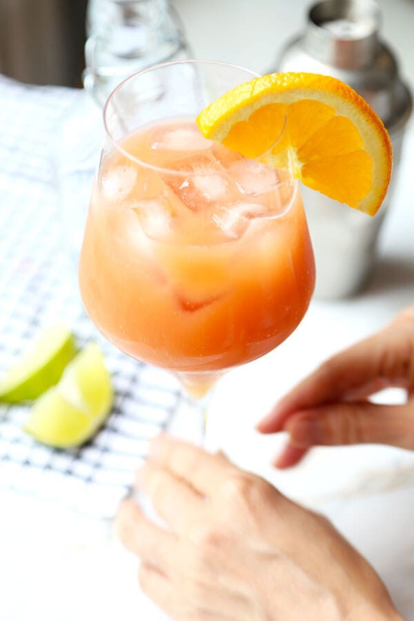 This Sex On The Beach cocktail just oozes fruity summer refreshment. Colored like a beautiful sunset, this is the perfect fruity mixed drink for a late-summer party! #howtomake #drinks #parties #fruitcocktail #alcoholicdrink #girlydrink | pickledplum.com