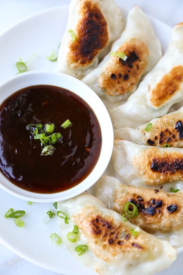 Shrimp Gyoza (Pan-Fried Dumplings) - Pillowy and tender pan-fried shrimp gyoza served with a fiery Szechuan spicy sauce. Recipe, dumplings, appetizer, snack, shrimp, gyoza | pickledplum.com