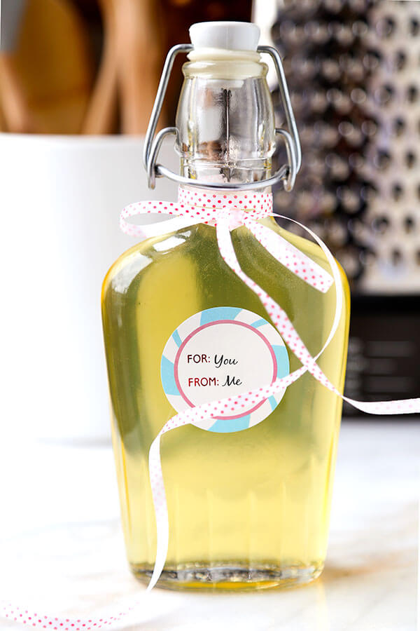 Limoncello - Make your own Limoncello this holiday season with just 3 ingredients! Serve it with soda and a splash of cranberry juice or bottle it up for the cutest and cheeriest homemade gift! Recipe, how to make limoncello, diy, alcohol, cocktail, vodka, drink | pickledplum.com