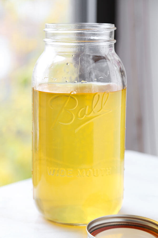 Limoncello - Make your own Limoncello this holiday season with just 3 ingredients! Serve it with soda and a splash of cranberry juice or bottle it up for the cutest and cheeriest homemade gift! Recipe, how to make limoncello, diy, alcohol, cocktail, vodka, drink | pickledplum.com