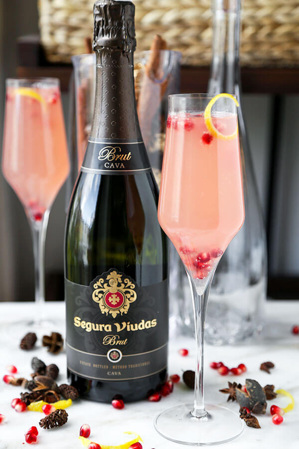 Spiked Pomegranata Cava - A pomegranate spiked Cava with plenty of zing! Grated ginger and lemon juice make this holiday cocktail a light and refreshing alternative. Recipe, drinks, Champagne, cocktail, New Year's, holiday | pickledplum.com