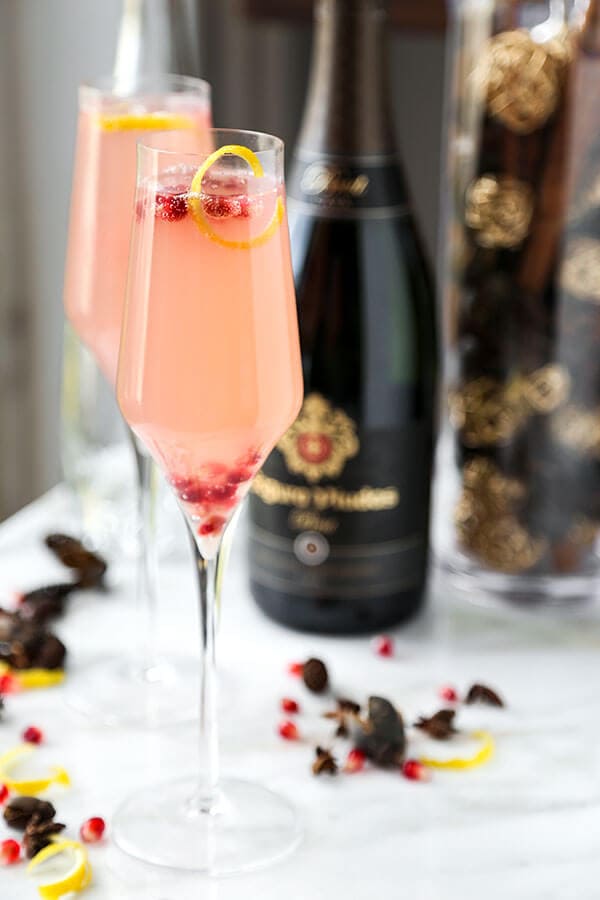 Spiked Pomegranata Cava - A pomegranate spiked Cava with plenty of zing! Grated ginger and lemon juice make this holiday cocktail a light and refreshing alternative. Recipe, drinks, Champagne, cocktail, New Year's, holiday | pickledplum.com