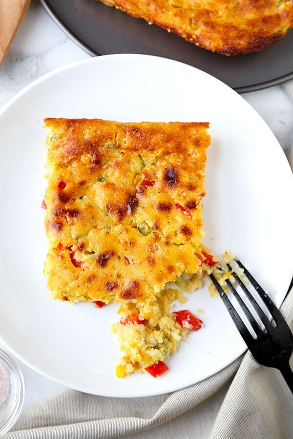 Lightened Up Corn Casserole - This Lightened Up Corn Casserole Recipe has the spirit of cornbread with the soul of a creamy autumn casserole. Ready in 40 minutes from start to finish! Recipe, Thanksgiving, Christmas, corn, side dish, baking | pickledplum.com