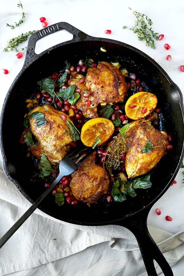 Curried Chicken With Pomegranate - Juicy curried chicken served with fresh basil, pomegranate and loads of pan fried garlic bits. Amazing and so easy! Ready in less than 25 minutes. Recipe, chicken, poultry, curry, dinner, easy meal, pomegranate, lemon | pickledplum.com