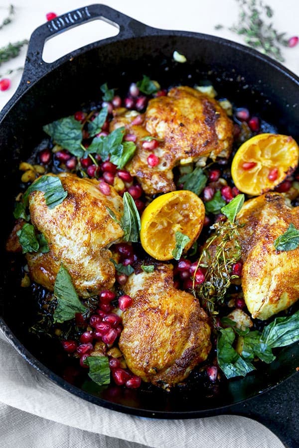 Curried Chicken With Pomegranate - Juicy curried chicken served with fresh basil, pomegranate and loads of pan fried garlic bits. Amazing and so easy! Ready in less than 25 minutes. Recipe, chicken, poultry, curry, dinner, easy meal, pomegranate, lemon | pickledplum.com